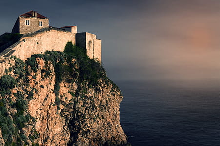 gray brick building on cliff thumbnail