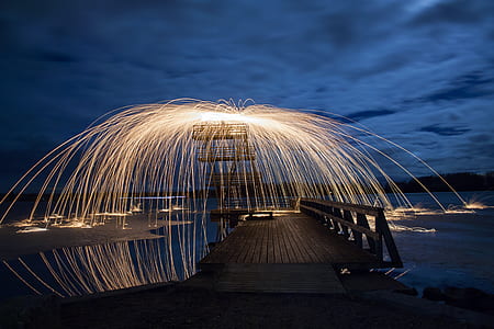 brown wooden dock during night time thumbnail