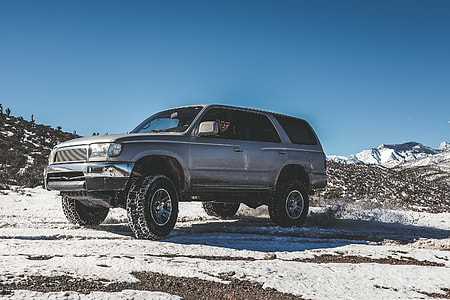 landscape photography of gray sport utility vehicle on snowland thumbnail