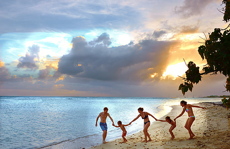 people having fun holding each other on sand beach during daytime thumbnail