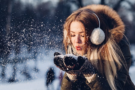 selective focus photo of woman blowing snow thumbnail