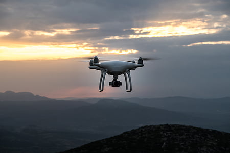 photo of flight of quadcopter drone on mid air during sunset thumbnail