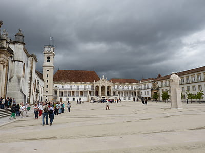 people standing near white buildings thumbnail
