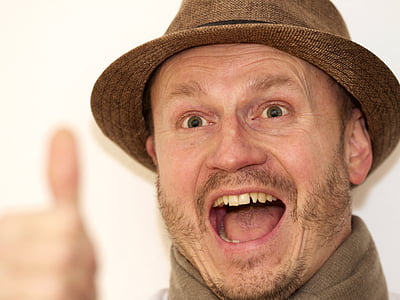 close-up photo of man open his mouth while doing thumbs up thumbnail