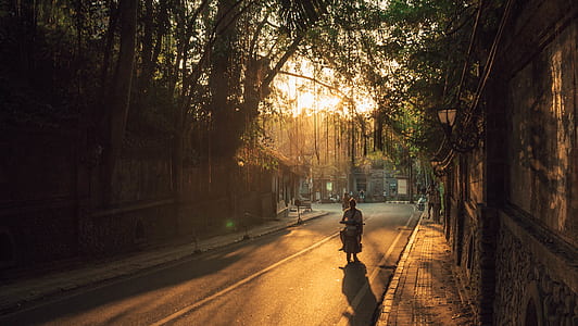 man riding motorcycle on road near concrete wall during golden hour thumbnail