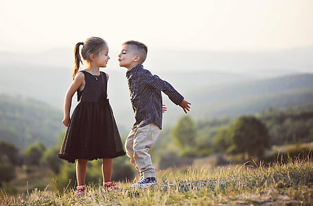 boy about to kiss girl on lawn field thumbnail
