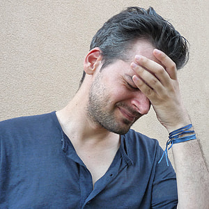 man holding his forehead thumbnail
