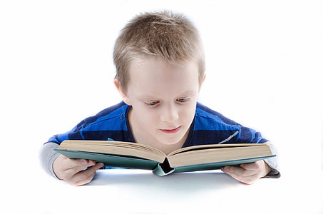 boy in blue and gray long-sleeved shirt reading book thumbnail