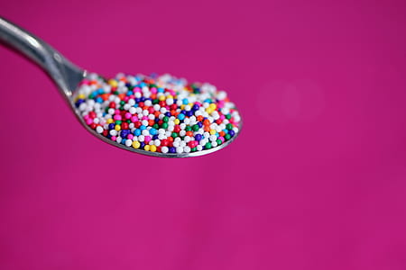 shallow focus photography of candies on spoon thumbnail