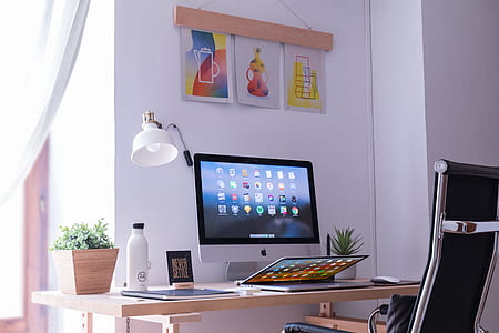 turned on silver iMac on desk thumbnail