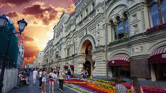 people standing between buildings during daytime thumbnail