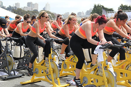 time lapse photography of women riding stationary bikes thumbnail