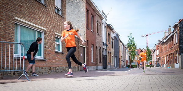 photo of women wearing orange t-shirt running on the streets thumbnail