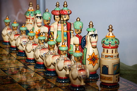 selective focus photography of brown and green chess piece on chessboard thumbnail