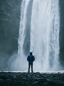 man facing waterfalls thumbnail