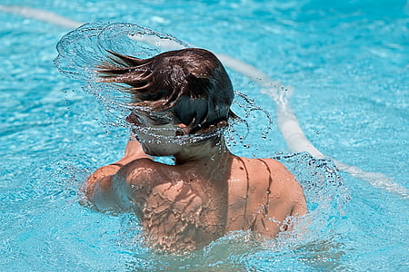 boy with black hair spinning head in pool thumbnail