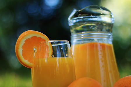 Glass and weighs detail with orange juice in nature thumbnail