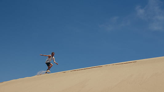man running on dessert at daytime thumbnail