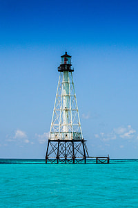 white and black tower in the middle of body of water thumbnail