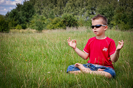 boy in red top sitting on grass thumbnail