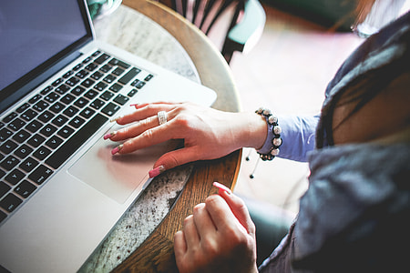 Girl Working on her MacBook in Caffe thumbnail