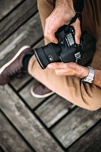 Photographer holding a DSLR camera thumbnail