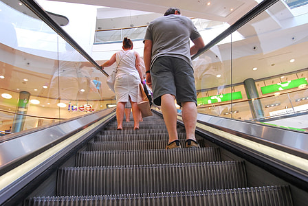 people on escalator inside establishment thumbnail
