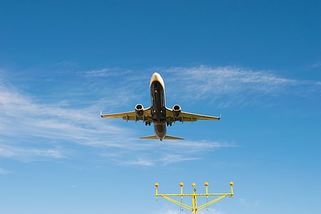 white airplane flying under blue sky thumbnail