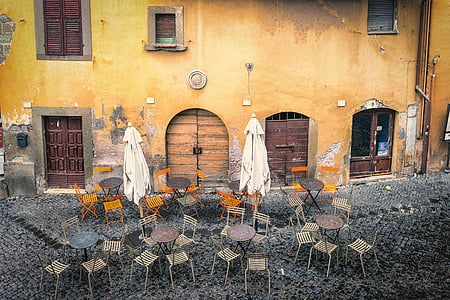 beige and black dining sets with two beige folded patio umbrellas at daytime thumbnail