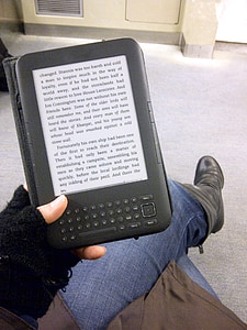 person holding Amazon kindle thumbnail