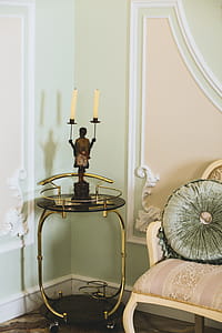 Black Metal Candle Holder on End Table Near Wall Inside the House thumbnail