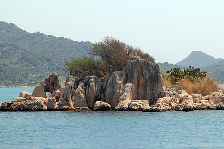 aerial view of brown island with mountain over body of water thumbnail