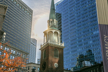 brown and gray building between two tall buildings thumbnail