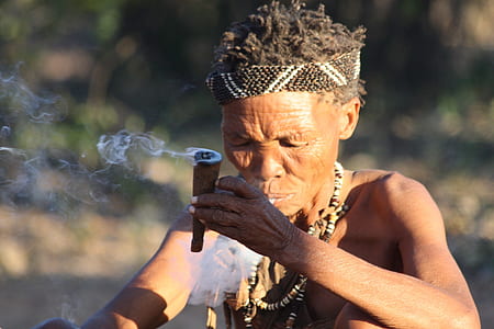 shallow focus photography of a woman holding brown cigar thumbnail