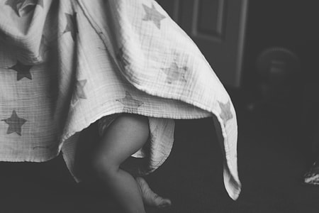 Baby in gray bed sheet thumbnail
