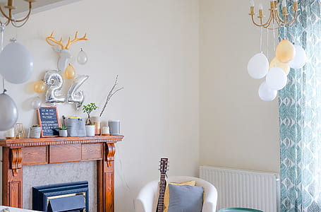 brown guitar leaned towards white wing chair thumbnail