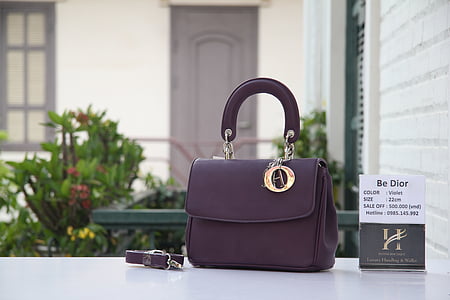purple leather two-way bag near wall thumbnail