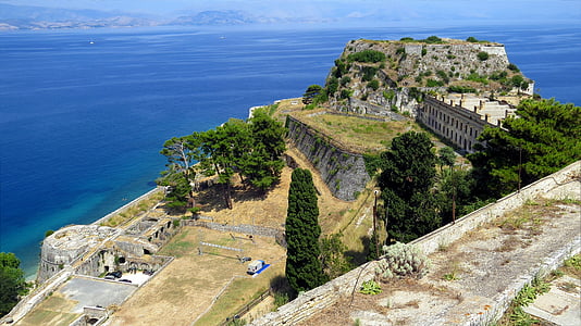 aerial photo of mountain surrounded by the body of water thumbnail