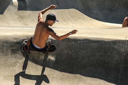 man wearing black shorts and cap riding skateboard thumbnail