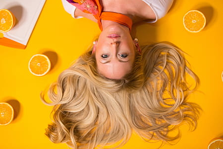 woman surrounded by orange fruits thumbnail