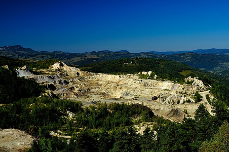 aerial view of mountains under blue sky during daytime thumbnail