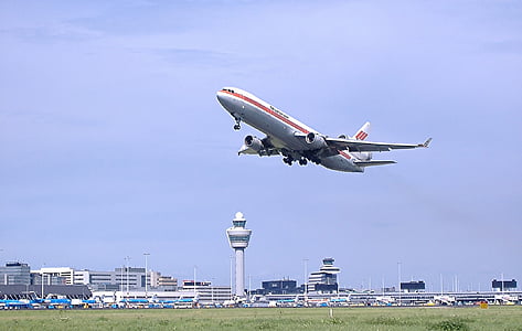 white airplane flying under sky at daytime thumbnail