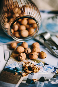 Jar full of walnuts with a fresh healthy shake and musli in a bowl thumbnail
