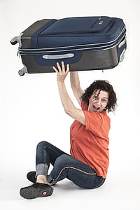 woman carrying black luggage thumbnail