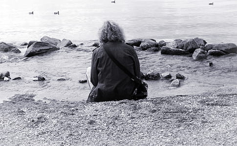 person sitting near sea shore thumbnail