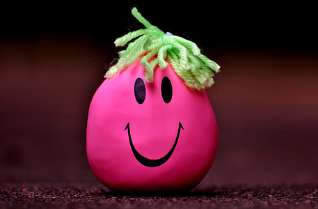 pink and green smiley face on brown ground thumbnail