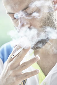 selective focus phot of a man smoking thumbnail