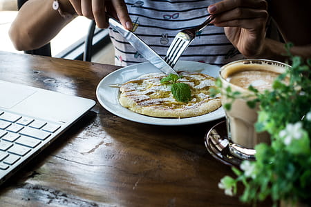 Girl eating pancake with honey in a coffeeshop thumbnail