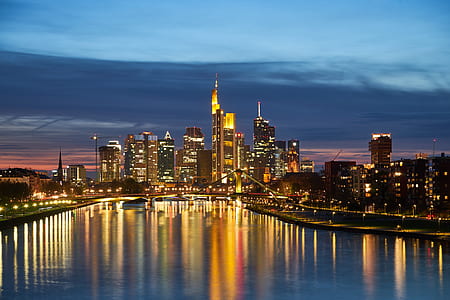 city skyline and lake photo during nighttime thumbnail
