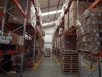 cardboard boxes piled on shelves inside warehouse thumbnail